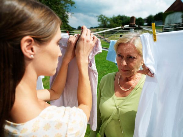 A young and older woman hanging clothes. | Source: Getty Images