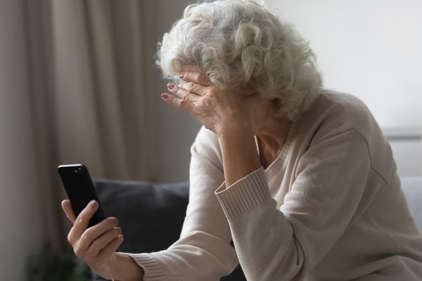 An older woman holding a cell phone