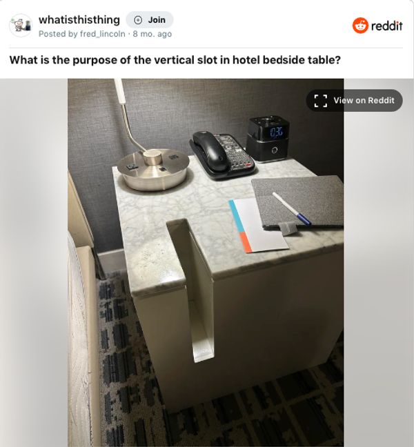 A vertical slot found in a hotel room bedside table | Source: Unknown