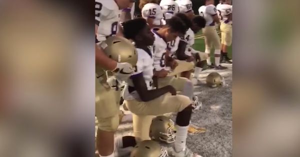 A Powerful Message: High School Football Team Takes a Knee During Anthem