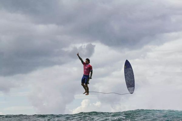 Gabriel Medina celebrates a wave at the 2024 Olympics. (JEROME BROUILLET/AFP via Getty Images)