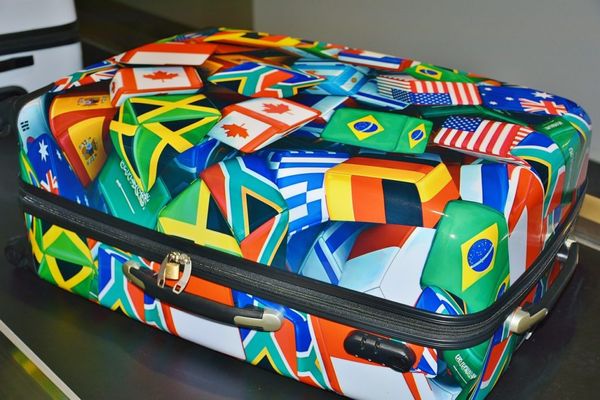 Luggage with flags from all over the world.