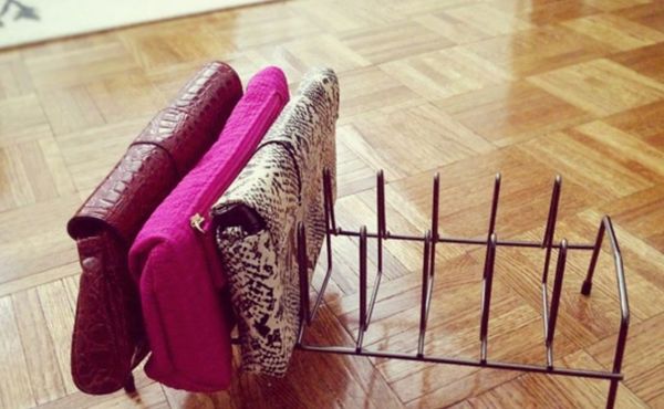 A dish rack with clutch purses.