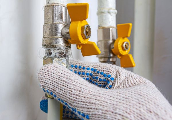 Gas leak at home. Inflating bubbles of soap mixture applied to the threaded joint on the gas pipe indicate a gas leak. Preventing a gas explosion disaster.