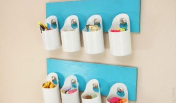 Blue coat racks repurposed with plastic containers for storage.